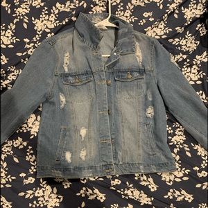 Light wash distressed jean jacket. Never been worn. Size XL